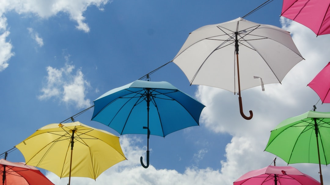 a-bunch-of-umbrellas-are-hanging-in-the-air-34ffvd8djy